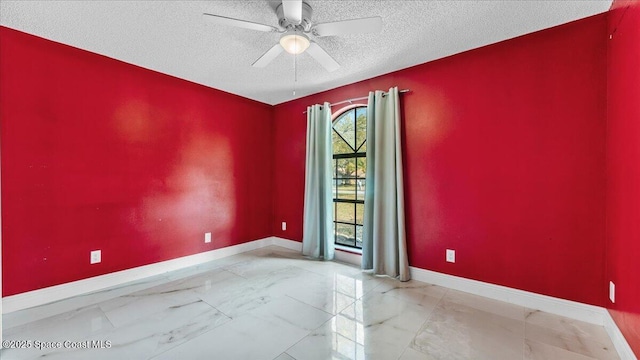 unfurnished room with ceiling fan and a textured ceiling