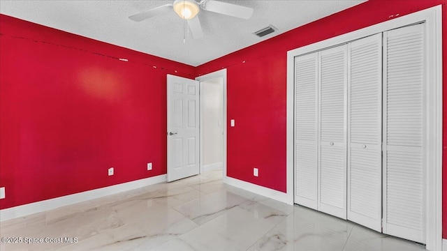 unfurnished bedroom featuring ceiling fan, a closet, and a textured ceiling