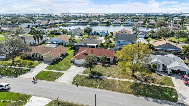 birds eye view of property with a water view