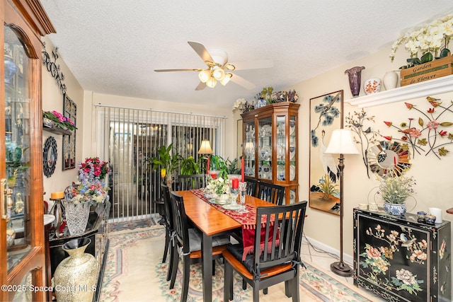 dining room featuring ceiling fan, tile patterned floors, and a textured ceiling