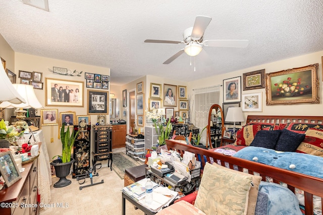 living room featuring ceiling fan, light colored carpet, and a textured ceiling