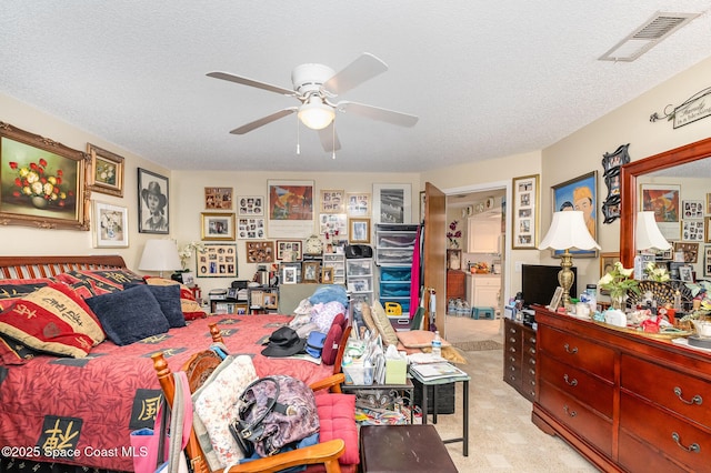 bedroom featuring ceiling fan, light carpet, and a textured ceiling