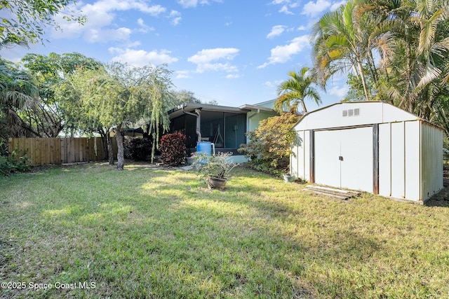 view of yard with a sunroom and a storage unit