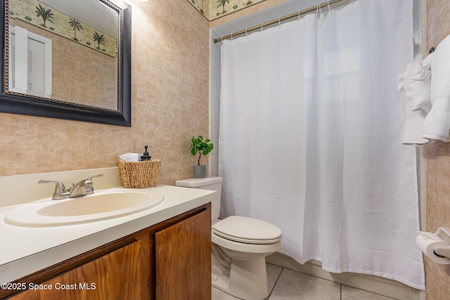 bathroom featuring vanity, toilet, and tile patterned flooring