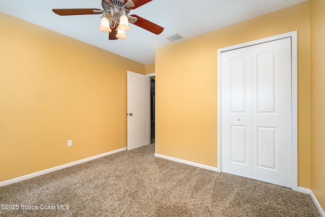 unfurnished bedroom with carpet floors, a closet, and ceiling fan