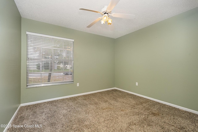 unfurnished room featuring ceiling fan, carpet flooring, and a textured ceiling