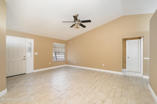 interior space featuring lofted ceiling, a textured ceiling, ceiling fan, and light hardwood / wood-style flooring