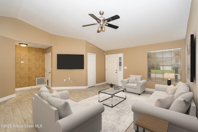 living room with ceiling fan, lofted ceiling, and light hardwood / wood-style flooring