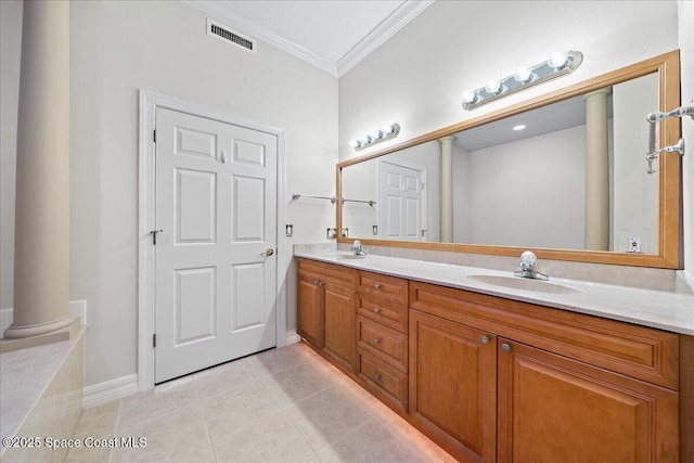 bathroom with decorative columns, vanity, ornamental molding, and tile patterned flooring