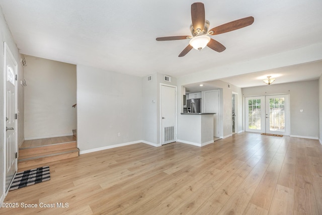 unfurnished living room with ceiling fan, light hardwood / wood-style floors, and french doors