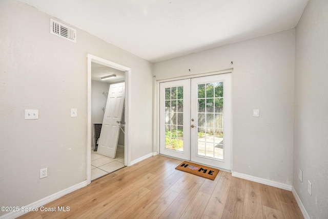 doorway featuring french doors and light hardwood / wood-style flooring