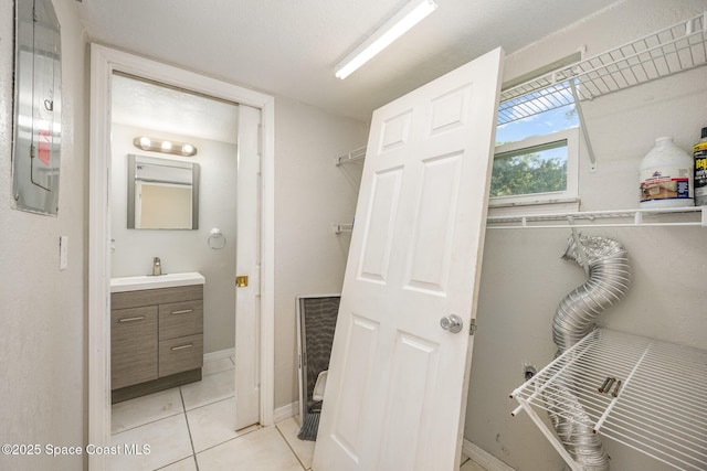 bathroom with tile patterned flooring and vanity