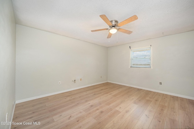 empty room featuring ceiling fan, a textured ceiling, and light wood-type flooring