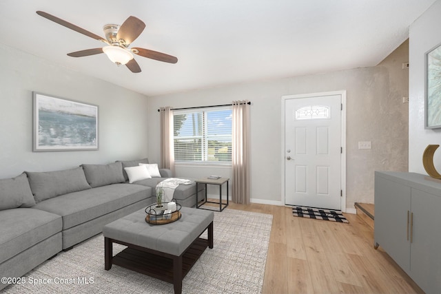 living room featuring ceiling fan and light wood-type flooring