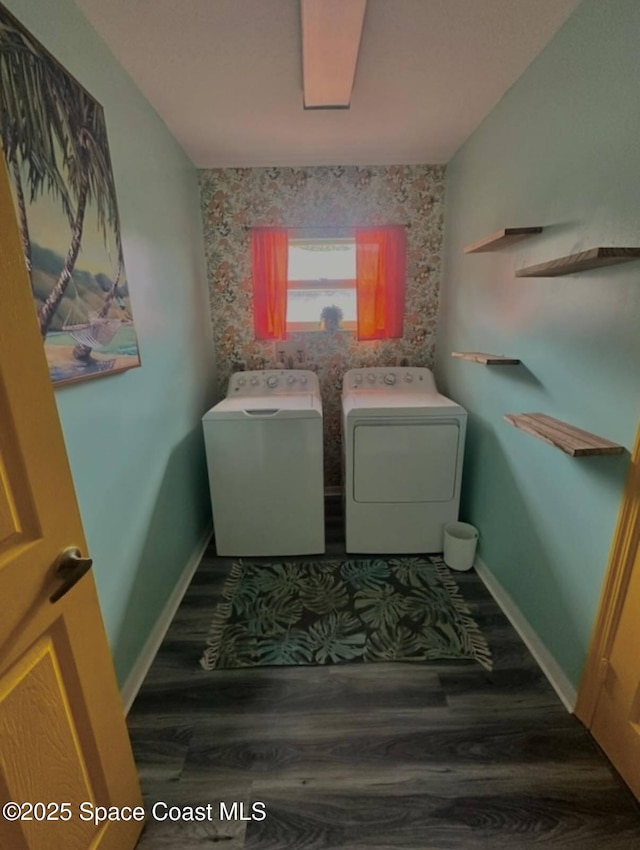 laundry area with baseboards, wood finished floors, laundry area, and washing machine and clothes dryer