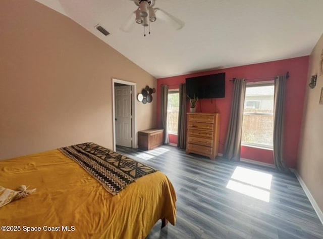 bedroom with a ceiling fan, wood finished floors, visible vents, baseboards, and lofted ceiling