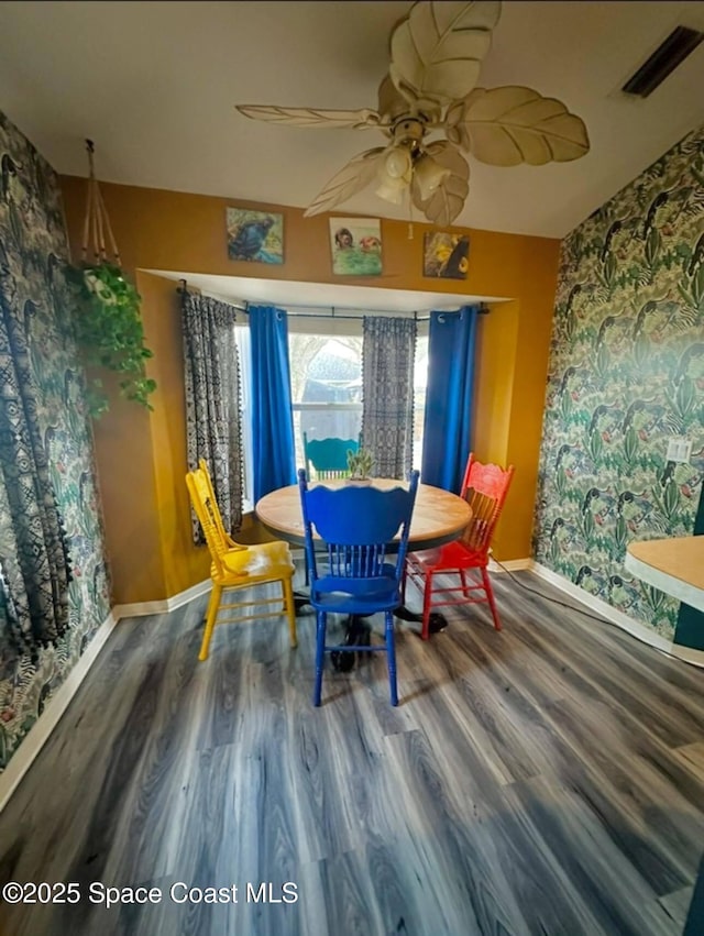 dining area with visible vents, baseboards, and wood finished floors