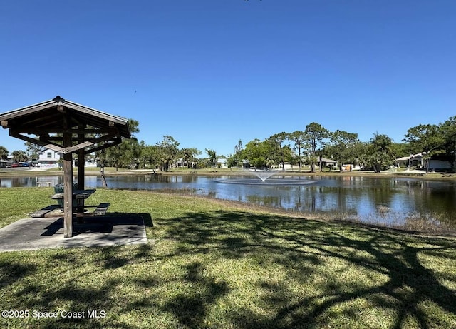 exterior space featuring a water view and a lawn