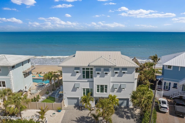 birds eye view of property with a water view and a view of the beach