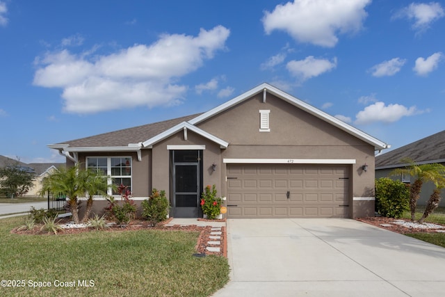 single story home with a garage and a front lawn