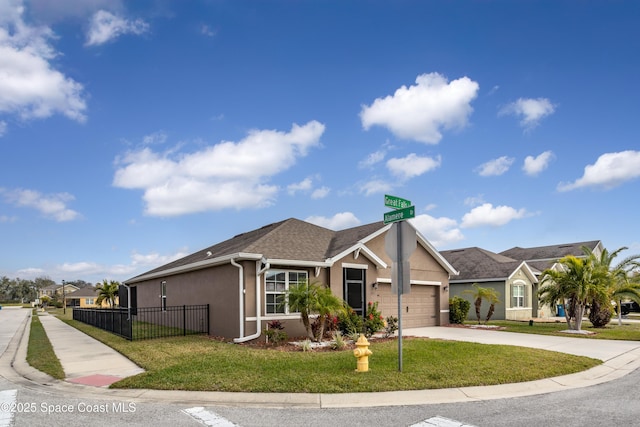 view of front of property with a garage and a front lawn