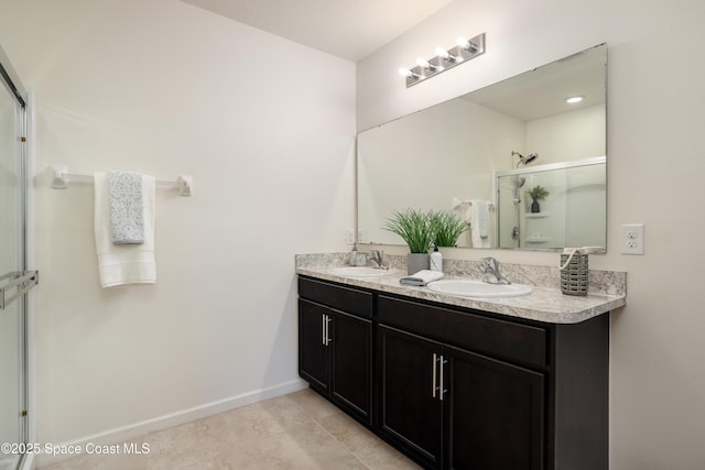 bathroom with vanity, tile patterned floors, and a shower with door