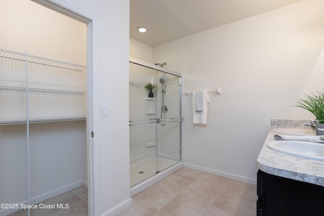 bathroom with vanity and a shower with shower door