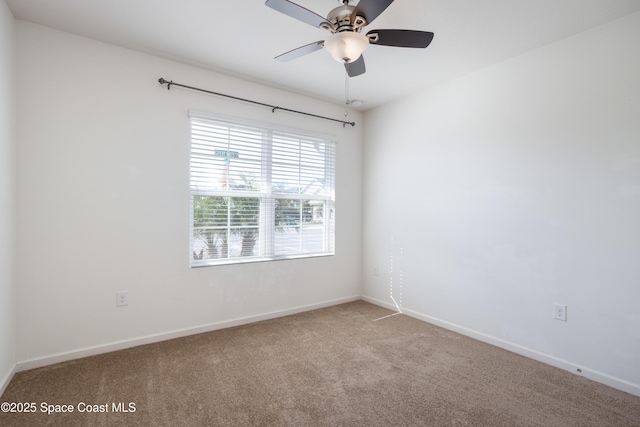 empty room featuring carpet flooring and ceiling fan