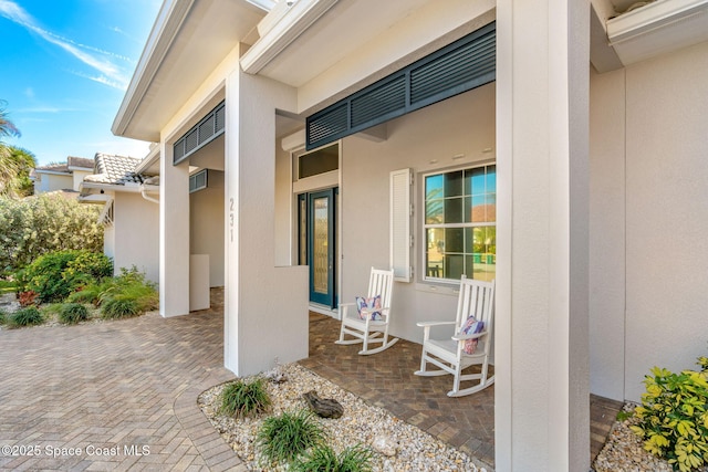 entrance to property featuring covered porch