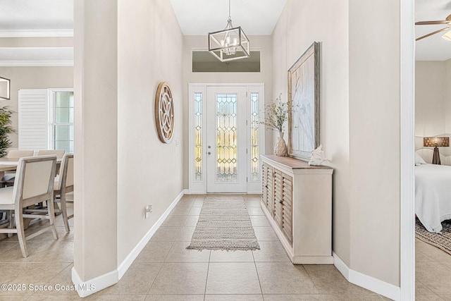 tiled entrance foyer with ceiling fan with notable chandelier