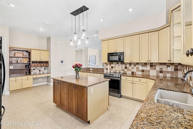 kitchen with sink, light stone counters, a kitchen island, pendant lighting, and black appliances