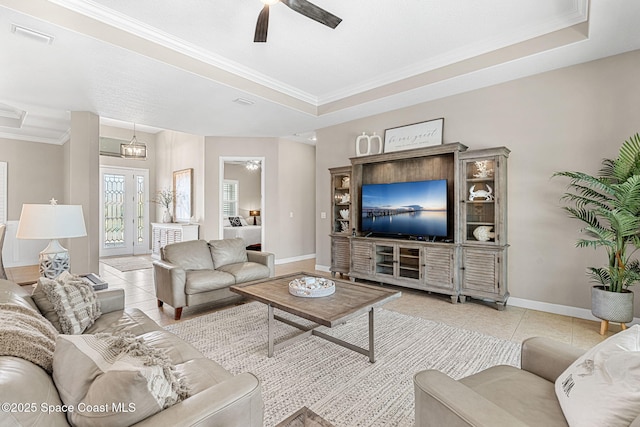 tiled living room featuring ornamental molding, a raised ceiling, and ceiling fan