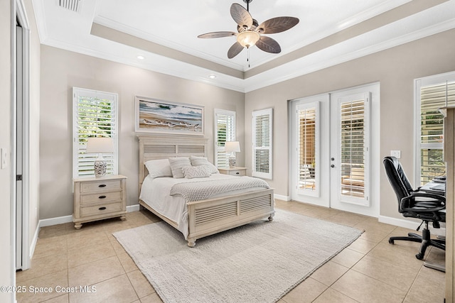 bedroom with light tile patterned floors, crown molding, access to exterior, french doors, and a raised ceiling