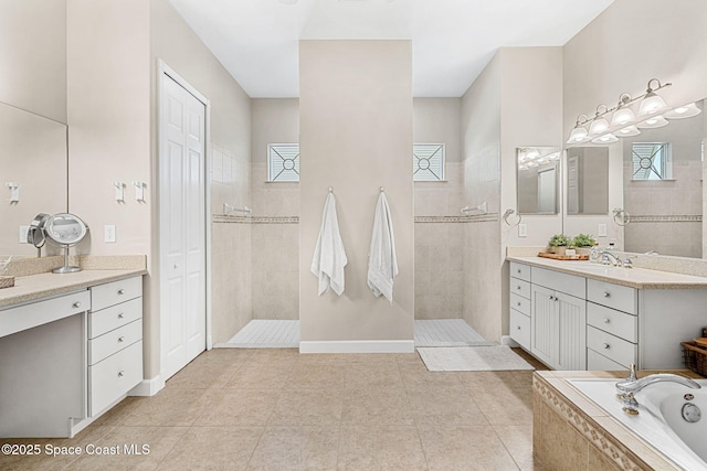 bathroom featuring tile patterned floors, vanity, and independent shower and bath