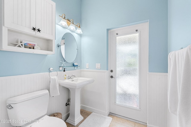 bathroom with tile patterned flooring, sink, plenty of natural light, and toilet