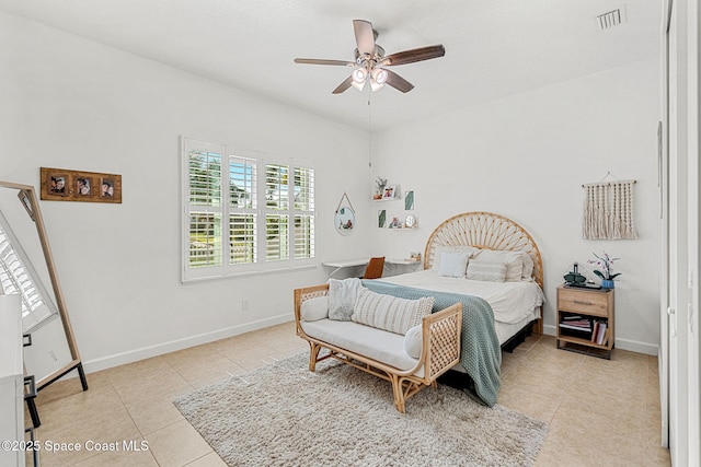 tiled bedroom featuring ceiling fan