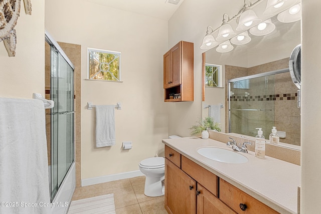 full bathroom featuring vanity, tile patterned floors, shower / bath combination with glass door, and toilet