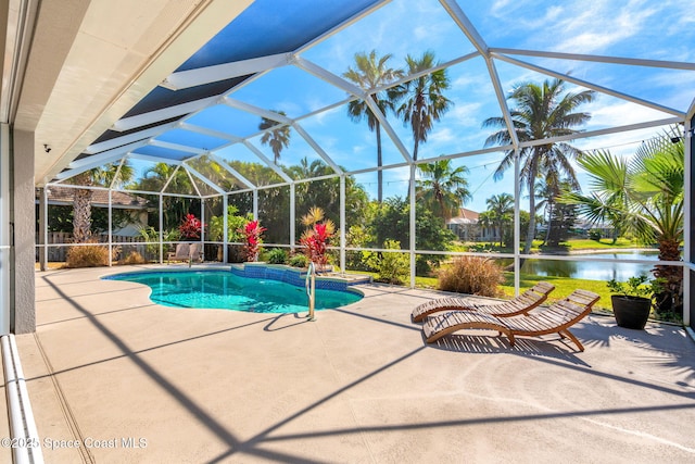 view of swimming pool with a water view, glass enclosure, and a patio area