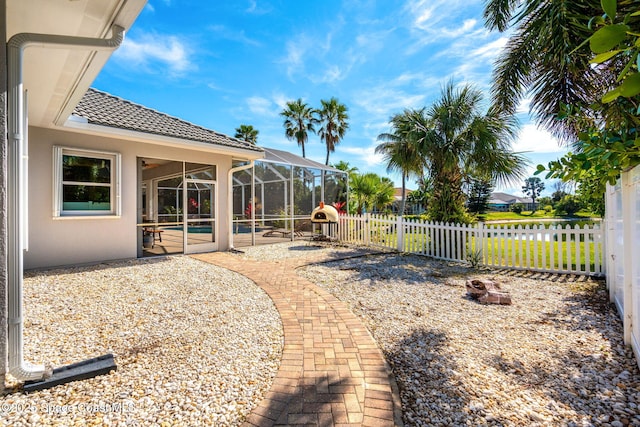 view of yard featuring an outdoor fire pit, a lanai, a fenced in pool, and a patio area