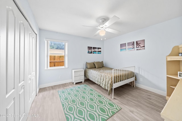 bedroom featuring ceiling fan, light wood-type flooring, and a closet