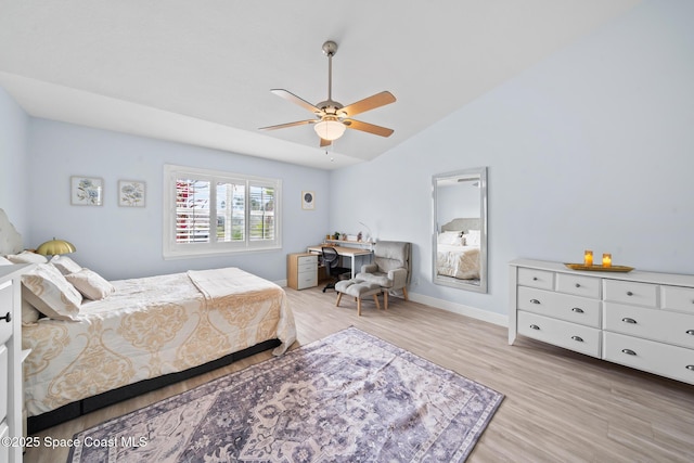 bedroom with ceiling fan, lofted ceiling, and light hardwood / wood-style flooring