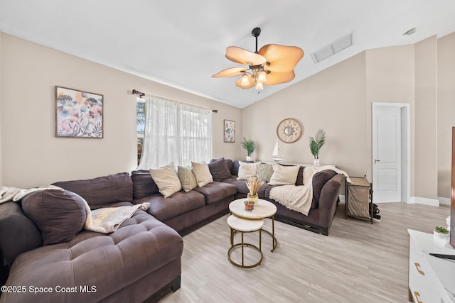 living room featuring lofted ceiling, ceiling fan, and light wood-type flooring