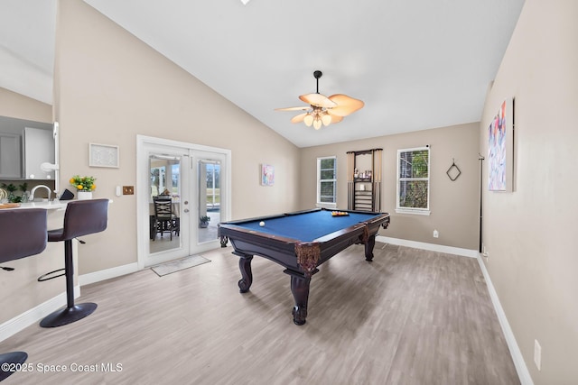 recreation room featuring lofted ceiling, a healthy amount of sunlight, light hardwood / wood-style flooring, and french doors