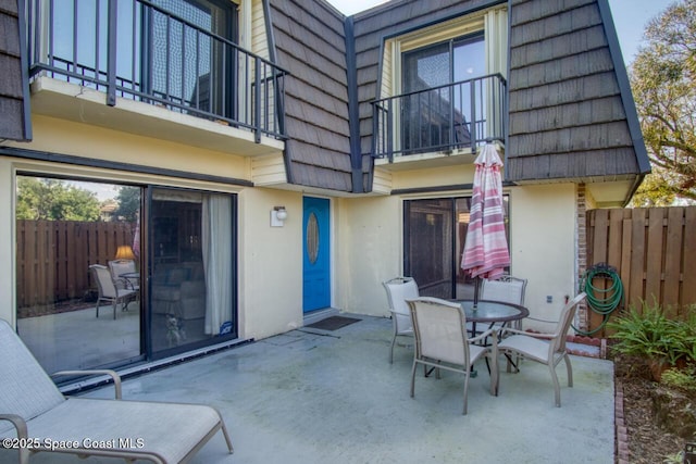 view of patio featuring a balcony