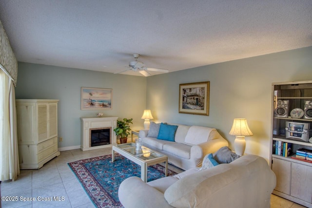 living room with light tile patterned floors, a textured ceiling, and ceiling fan