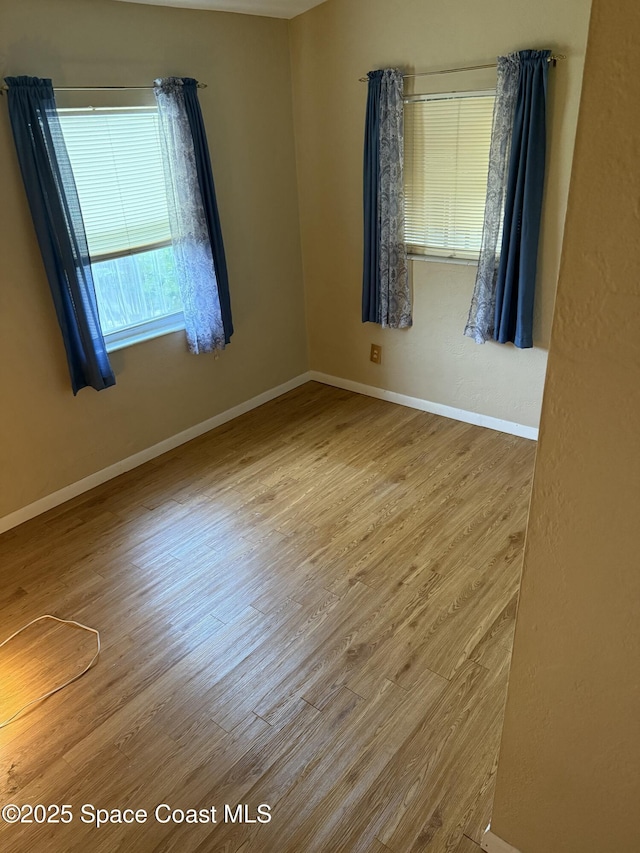 spare room with hardwood / wood-style flooring