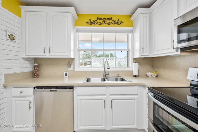 kitchen featuring white cabinetry, appliances with stainless steel finishes, sink, and backsplash