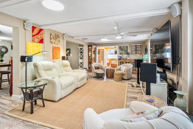 living room with beam ceiling, ceiling fan, and light hardwood / wood-style flooring