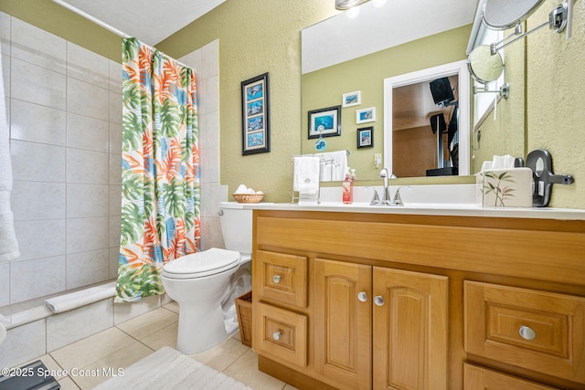 bathroom featuring walk in shower, vanity, toilet, and tile patterned flooring