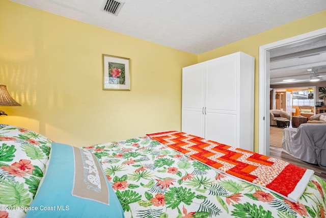 bedroom featuring wood-type flooring and a textured ceiling